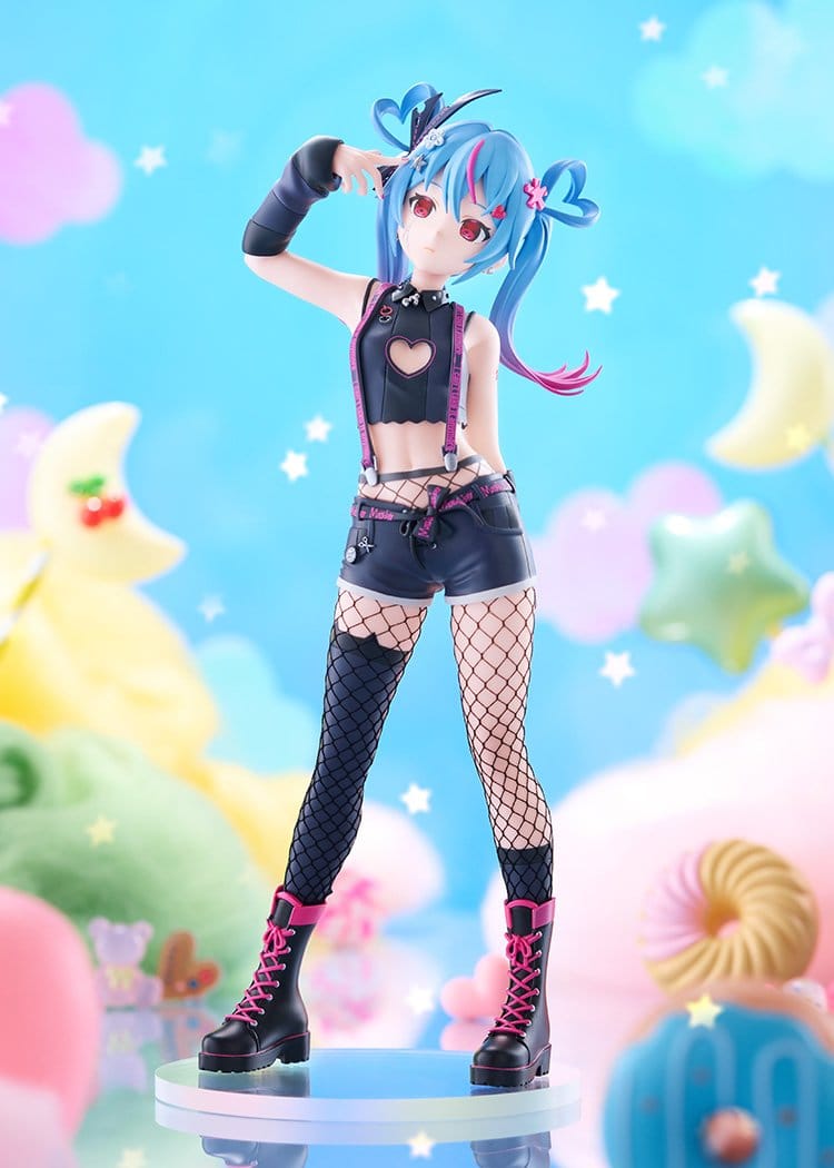 A stylized anime figurine of a girl with blue and pink twin-tails, wearing a black crop top with a heart cutout, denim shorts, fishnet stockings, and black lace-up boots with pink laces, posed on a round display base against a pastel dreamy background.