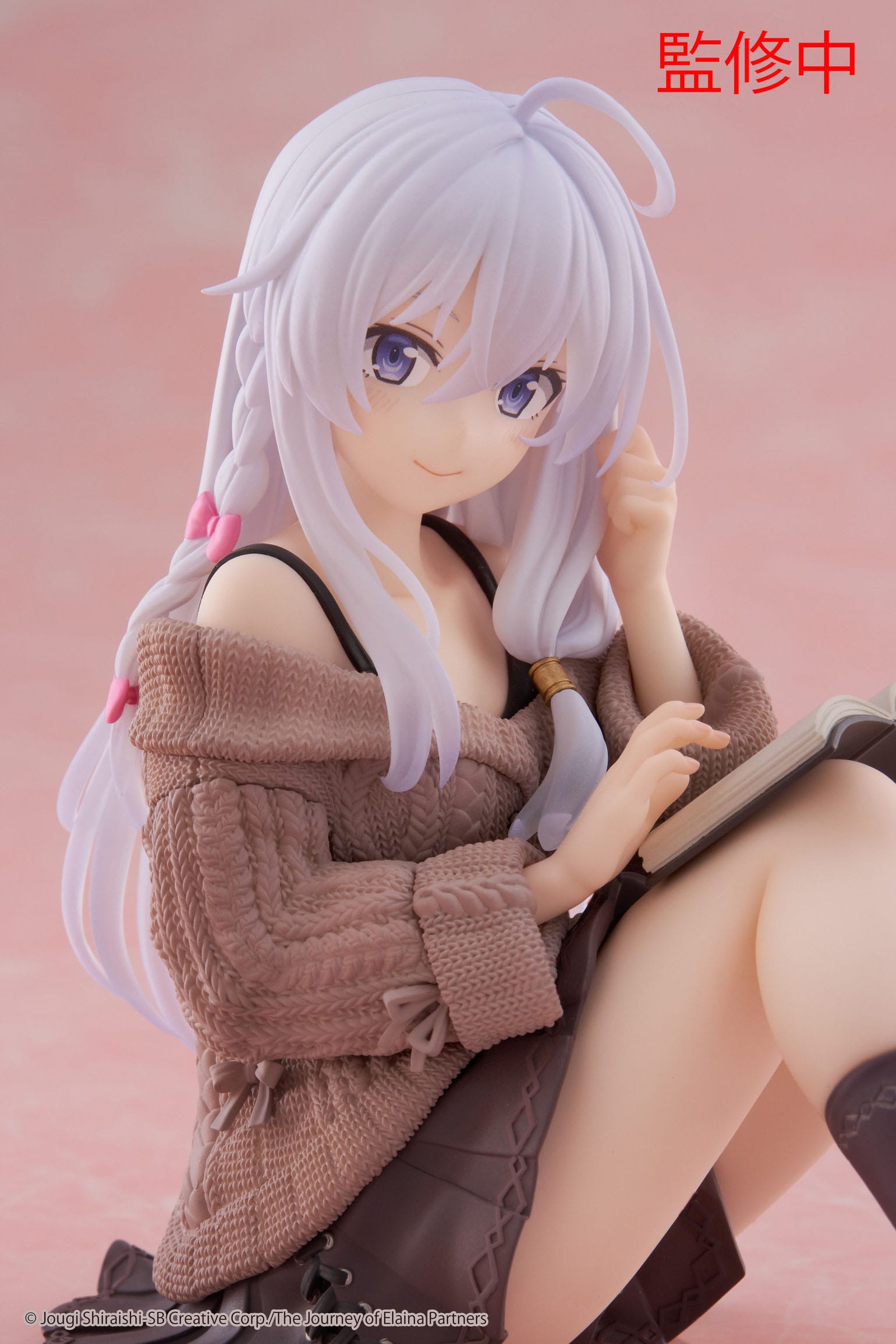 Anime character figurine with white hair and a brown outfit on a pink background