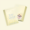 Yellow Seasons Greetings box with blue writing on a white background