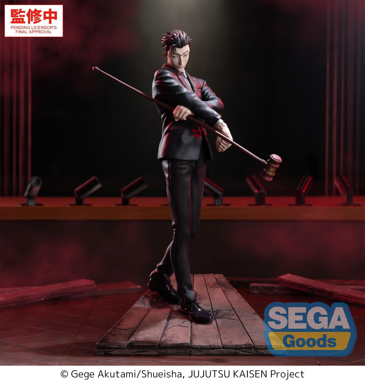 Action figure of a character from 'Jujutsu Kaisen' holding a rod on a stage with red curtains.