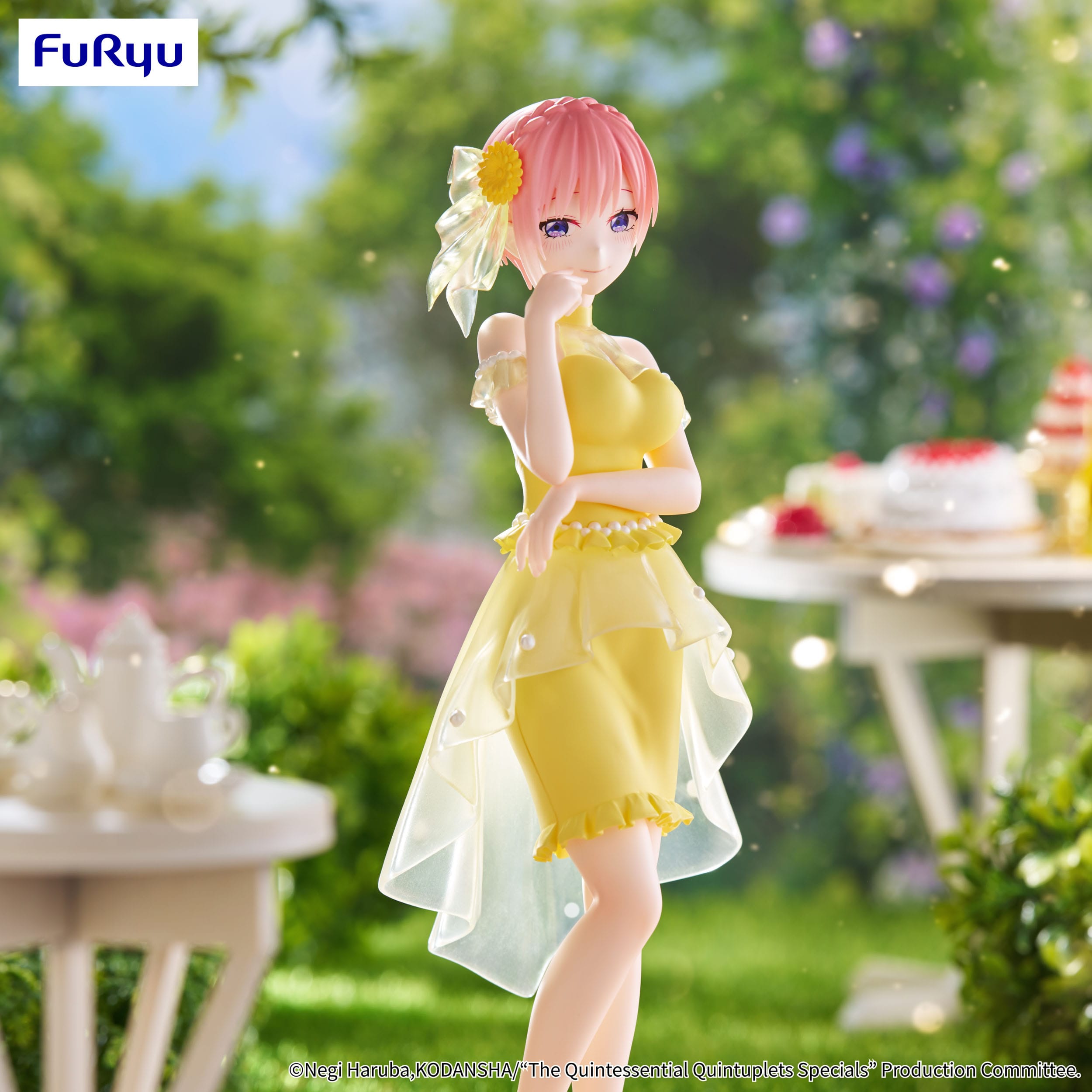 Figurine of a character in a yellow dress with a flower in hair, standing outdoors with blurred background