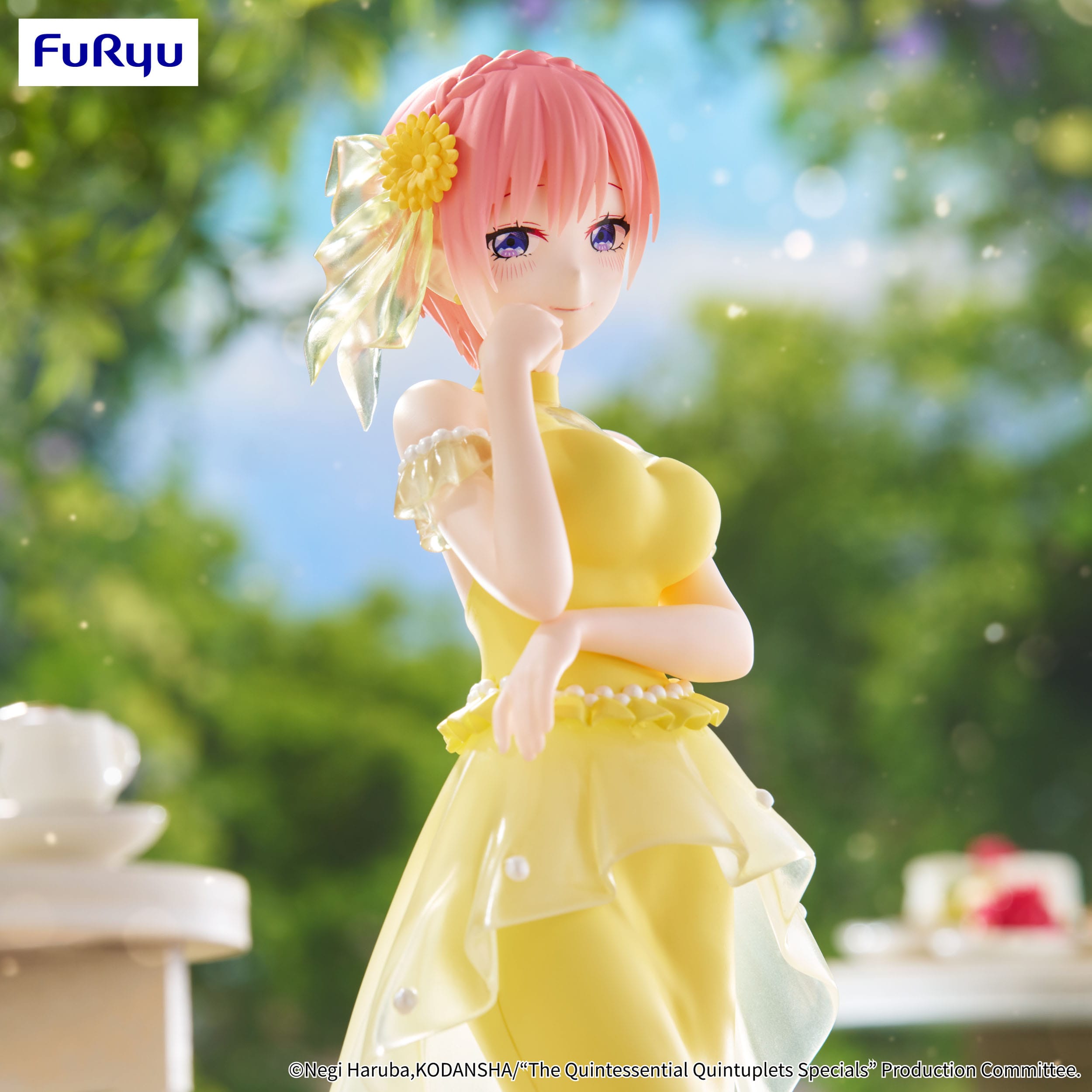Figurine of a character in a yellow dress with a flower in her hair, standing outdoors.