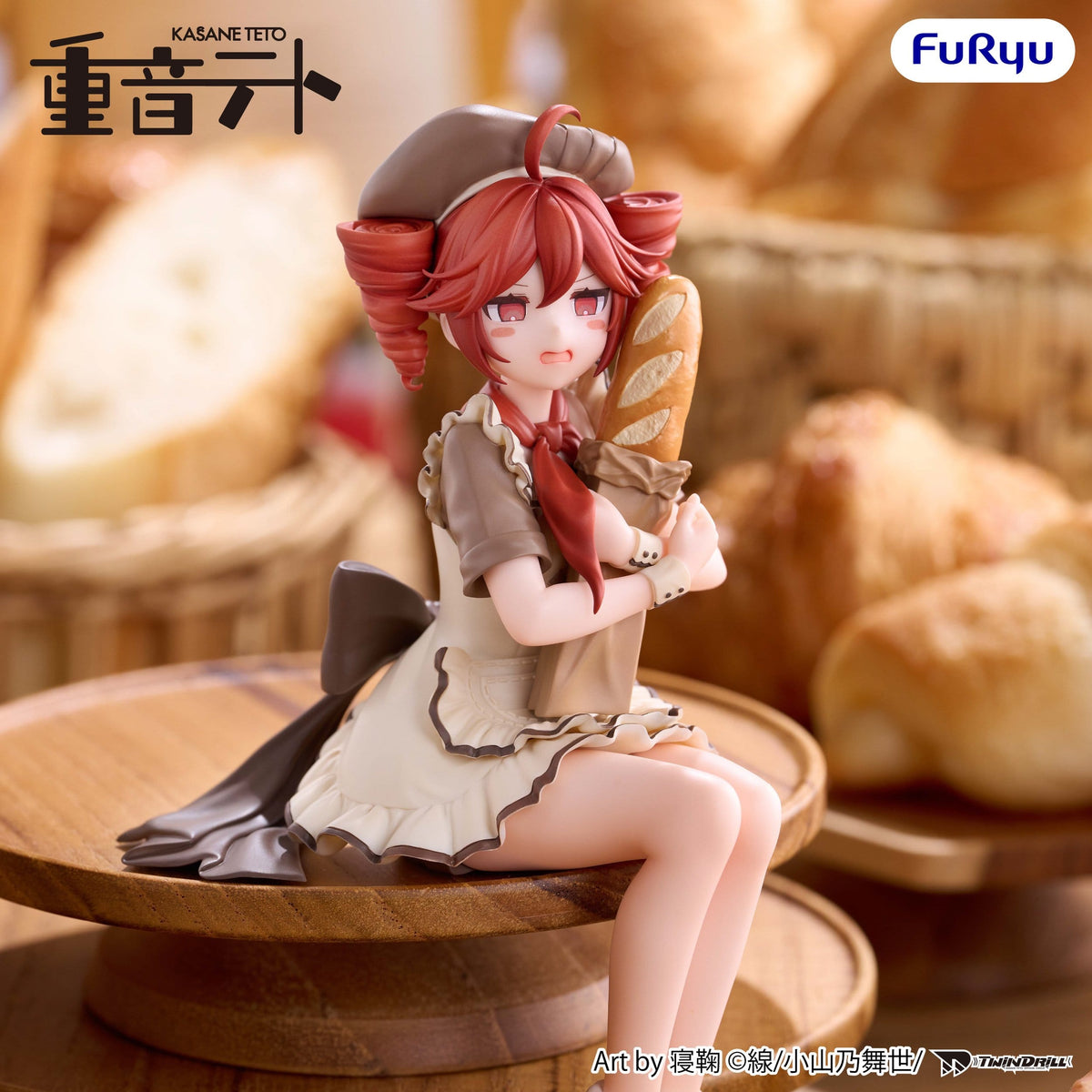 A detailed anime figurine of Kasane Teto, depicted as a pastry chef holding a baguette. The figure is seated on a wooden stand against a warm, blurred background of bread baskets and pastries.