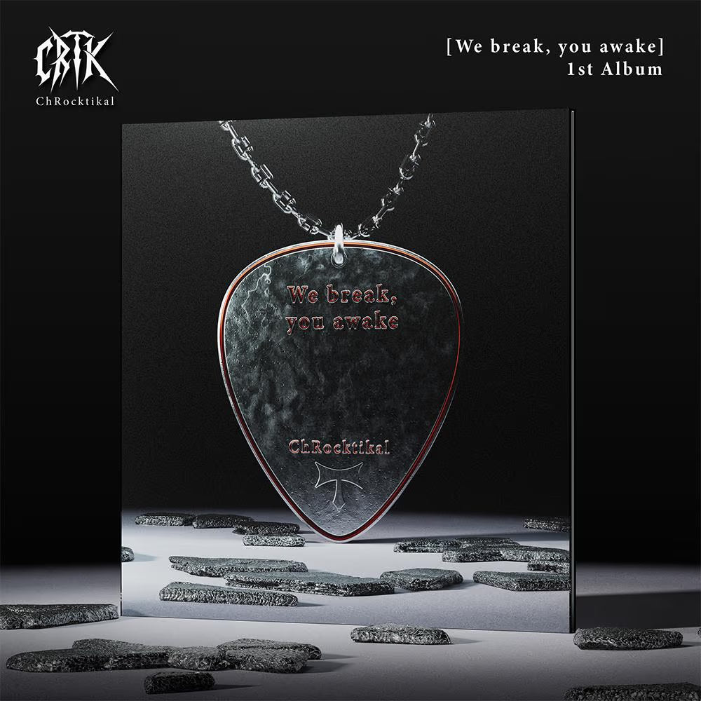 Guitar pick-shaped pendant with 'We break, you awake' text on a black background