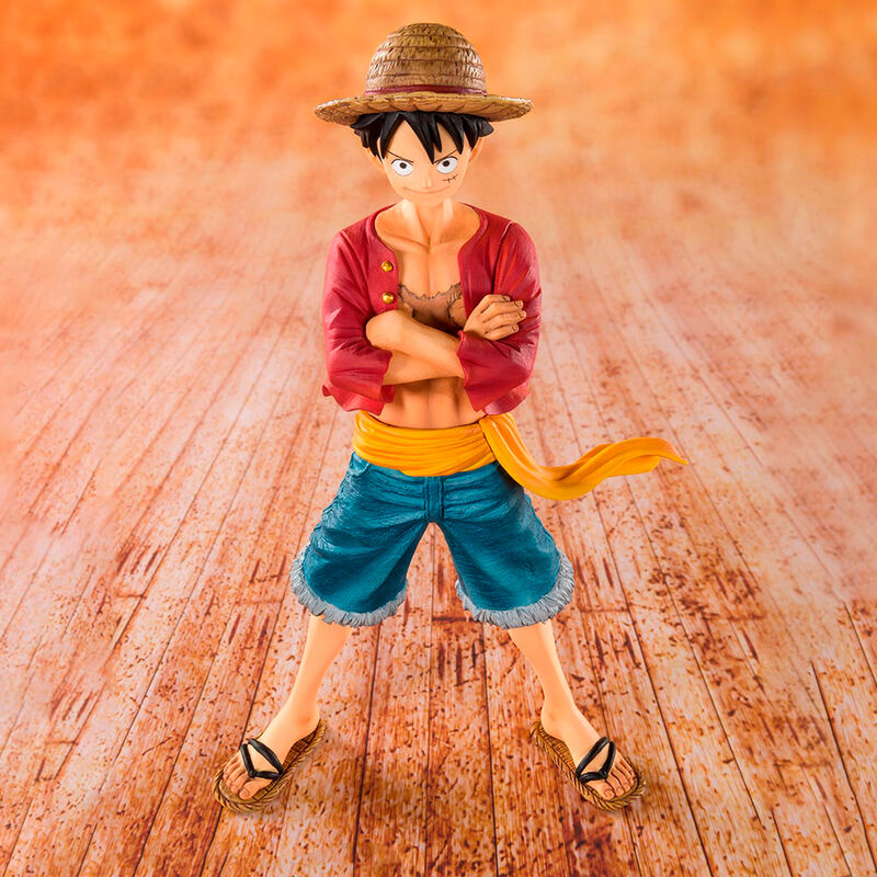 Figurine of a character with a straw hat on a wooden floor background