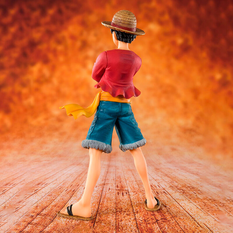 Figurine of a character with a red shirt and straw hat on an orange background