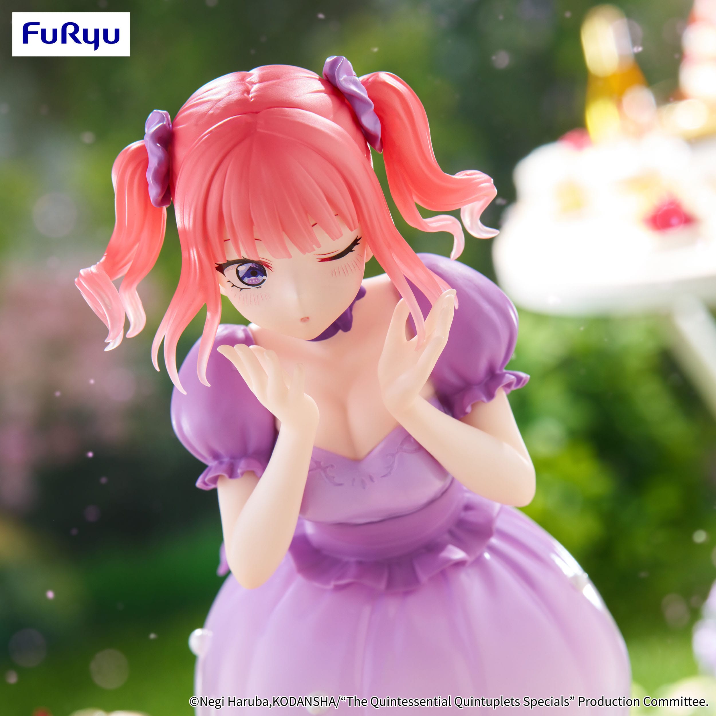 Figurine of a character with pink hair and a purple dress, blurred background