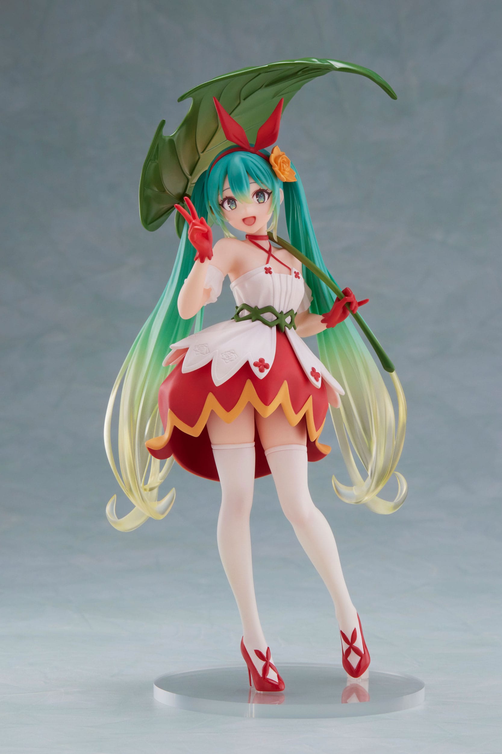 Colorful figurine with green hair and red outfit on a gray background
