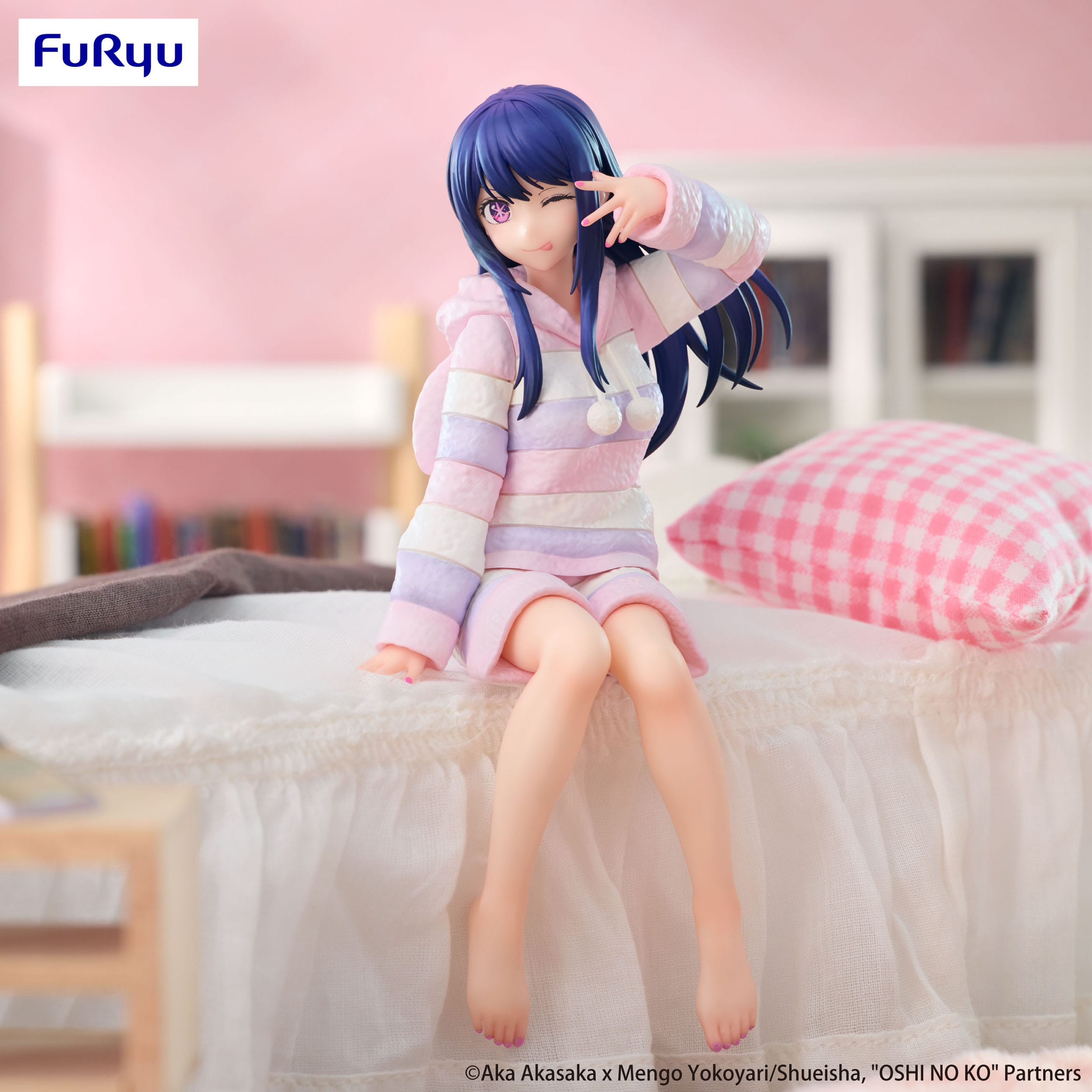 Figurine of a character in a striped outfit sitting on a bed with a blurred background
