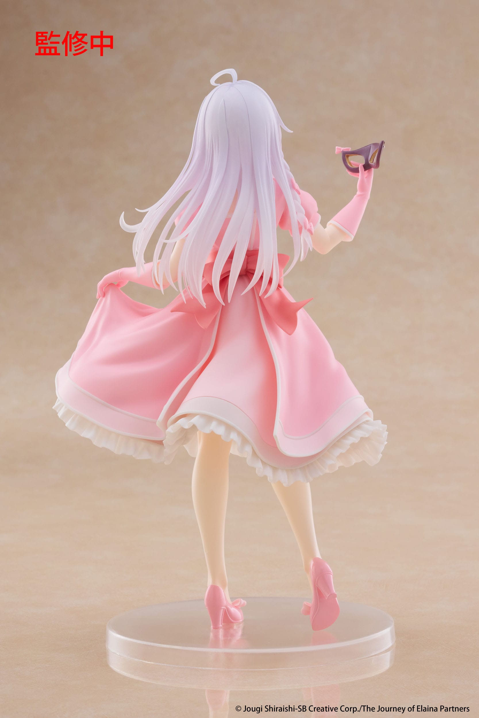 Figurine of a character in a pink dress with white hair on a beige background