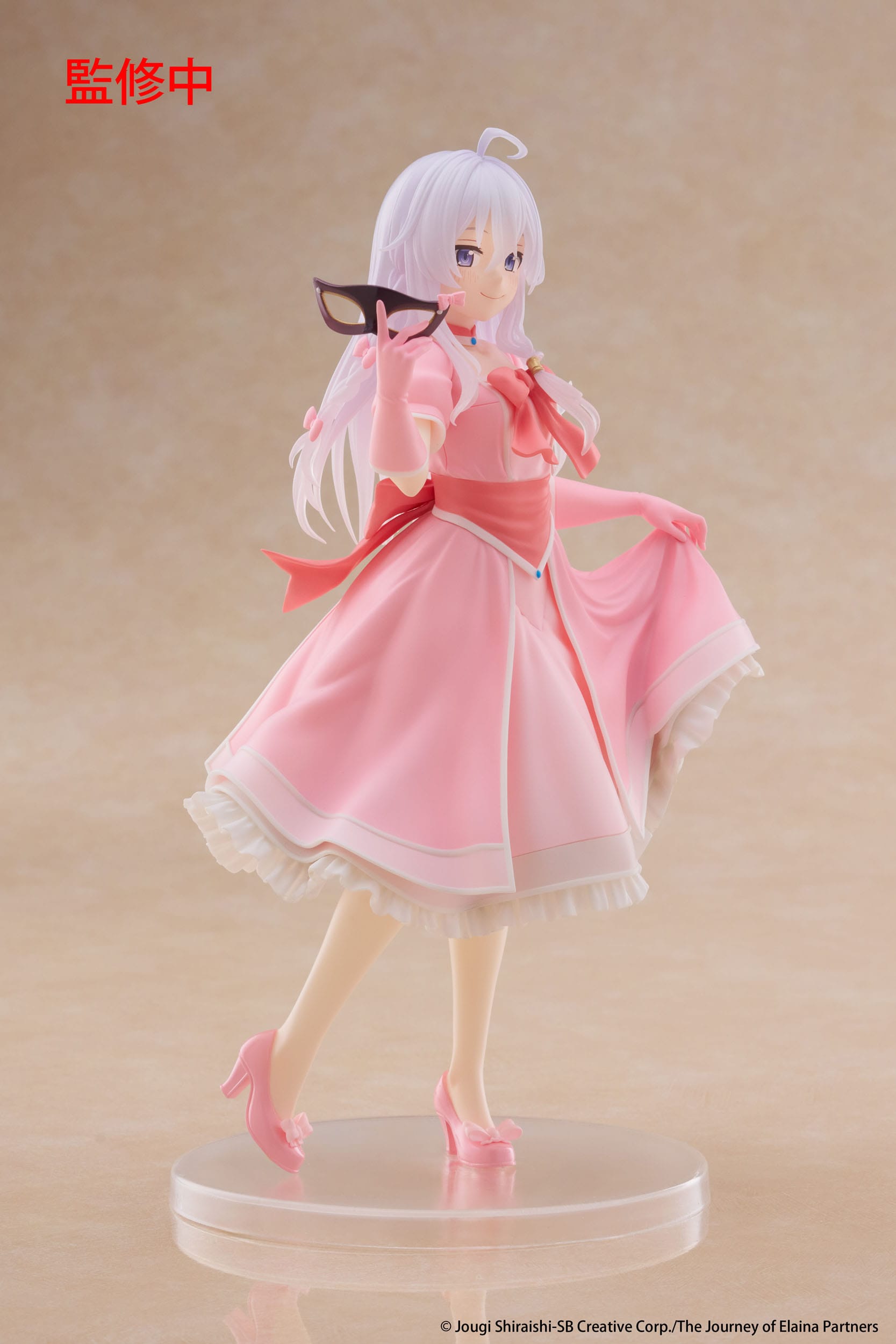 Figurine of a character in a pink dress on a beige background