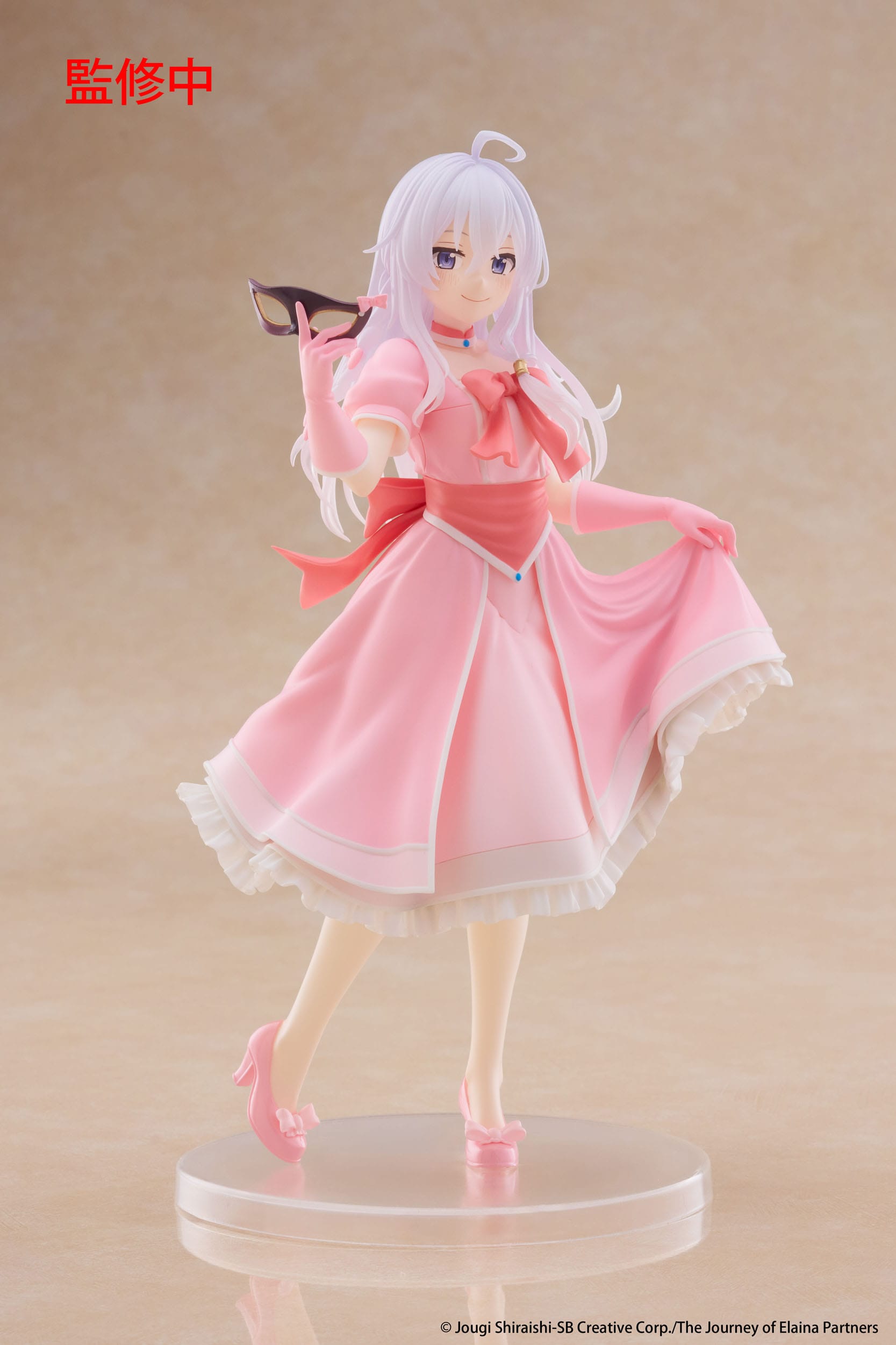 Figurine of a character in a pink dress with cat ears on a beige background