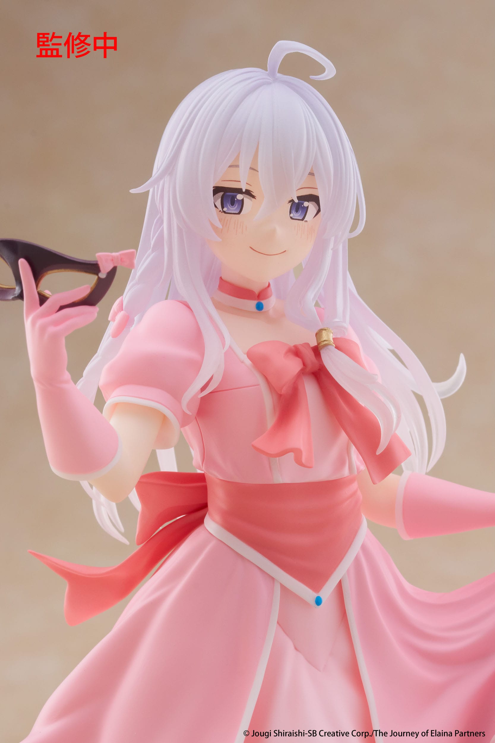 Anime character figurine in a pink outfit with a neutral background